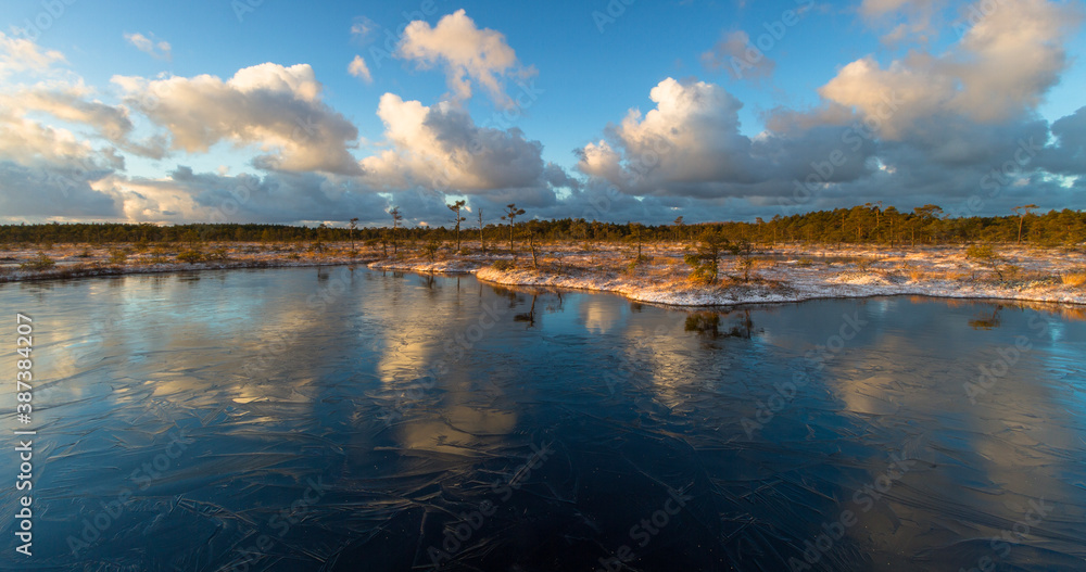 Swamp lake with islands in sunny winter day in sunrise Swamp lake with islands in sunny winter day in sunrise