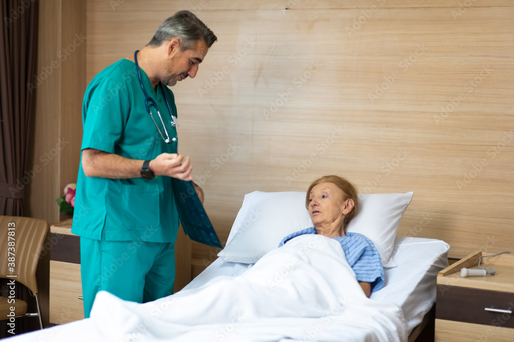 Fototapeta premium Physician examining senior woman patient in hospital room. Healthcare and medical background concept