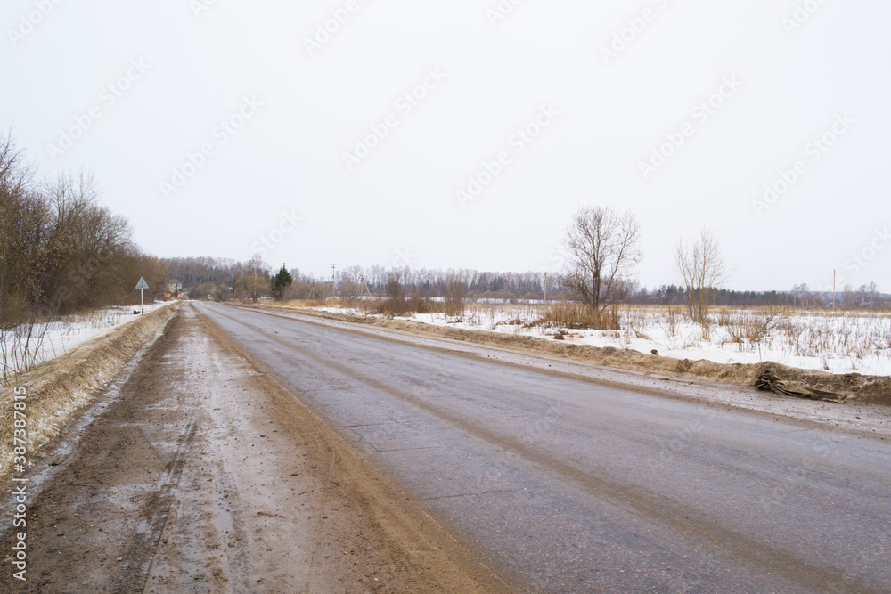 Winter road in the snow on a cloudy day