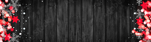 Christmas / Advent background banner Panorama, card template -Red stars, bokeh lights, ice crystals and snowy snowflakes, isolated on dark black wooden bards wall texture wood, with copy space