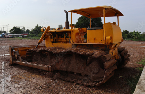 yellow bulldozer on the road © Chavalit
