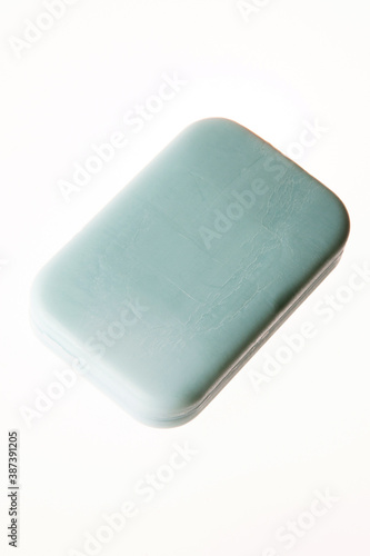 A bar of natural blue soap isolated on white background. Studio shot. Hygiene theme - bacteria and virus prevention