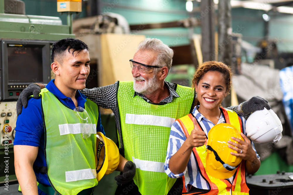 Man and Woman engineering wearing safety goggles and hard hats giving high five and celebrating success. Metal lathe industrial manufacturing factory Man and Woman engineering wearing safety goggles and hard hats giving high five and celebrating success. Metal lathe industrial manufacturing factory