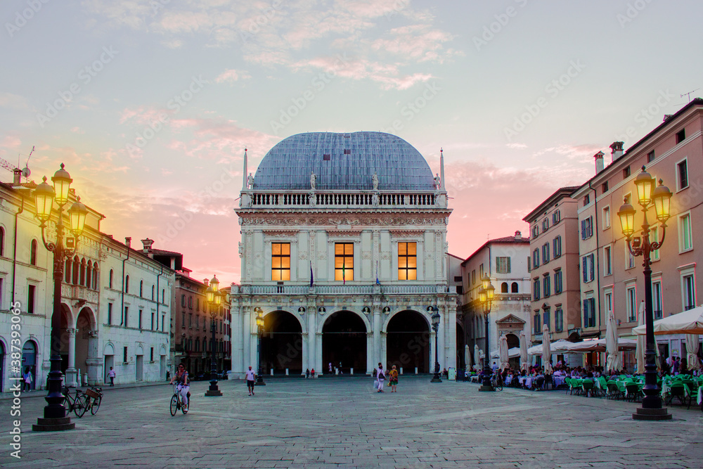 Panoramic view of Loggia palace ( palazzo della loggia) of Brescia square during sunset at the end of the summer.