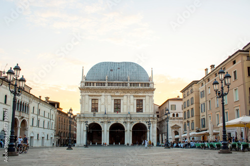 Panoramic view of Loggia palace ( palazzo della loggia) of Brescia square during sunset at the end of the summer.