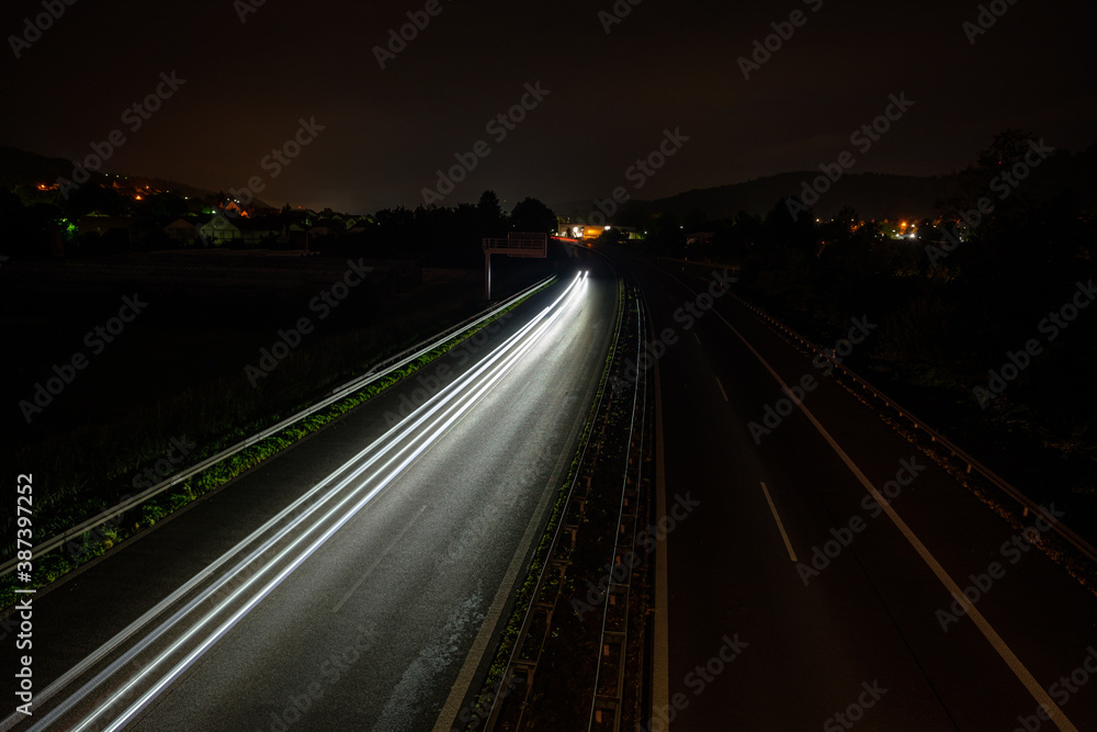 White car lights on a road in night