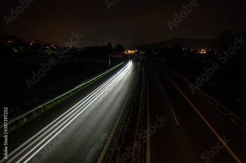 White car lights on a road in night