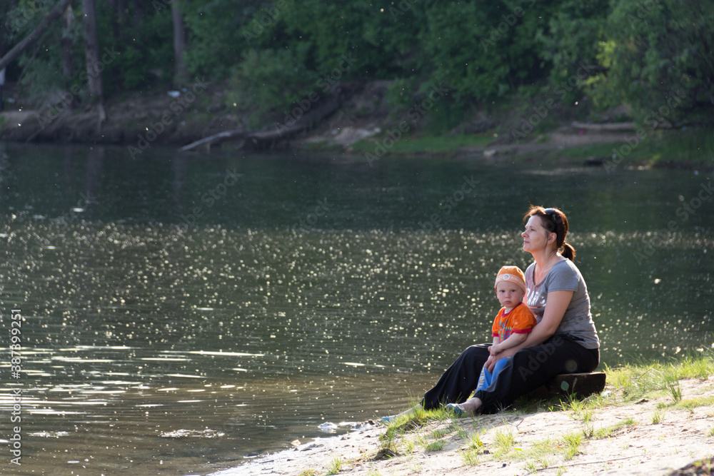 Fototapeta premium mother with little son by the water on the lake