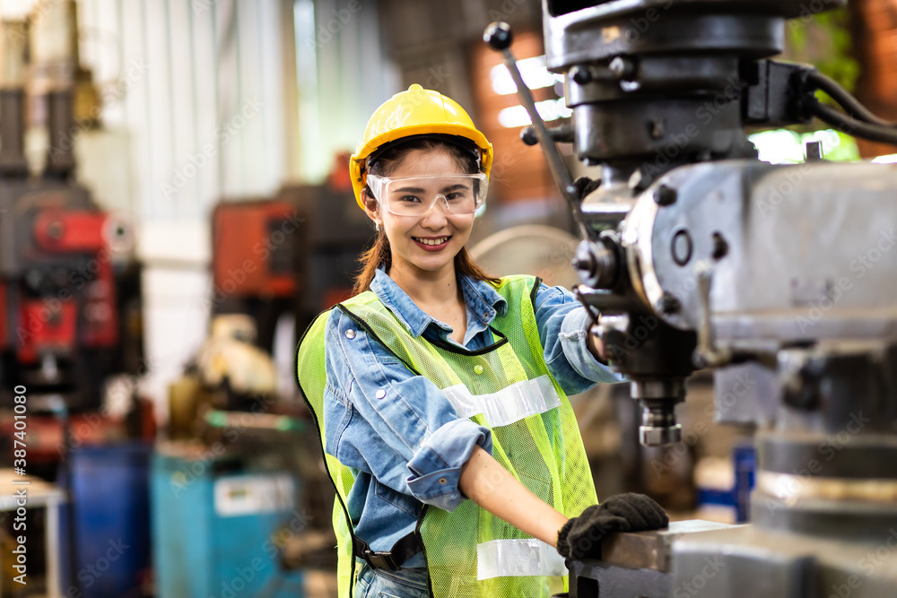 custom made wallpaper toronto digitalWoman worker wearing safety goggles control lathe machine to drill components. Metal lathe industrial manufacturing factory