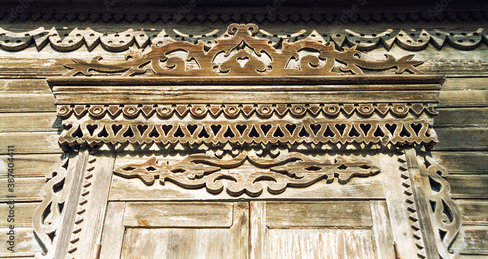 Fragment of the Window of an old Russian wooden house from the times of the Russian Empire with elements of carved decorations.
Astrakhan, Russia.