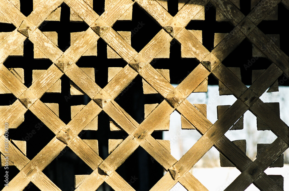 Fototapeta premium Wooden lattice - Element of decoration of the gate Antique Russian wooden house of the times of the Russian Empire