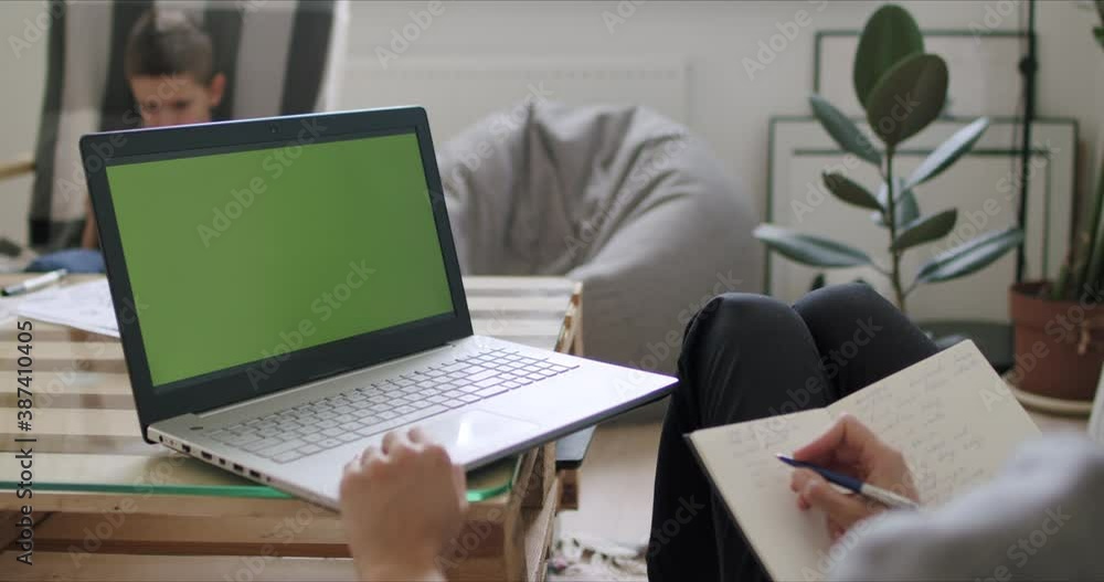 Woman holding computer with green screen Woman holding computer with green screen