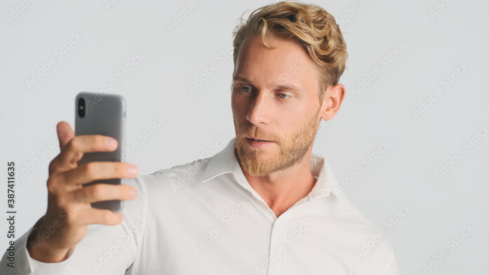 Handsome bearded businessman confidently talking on video chat isolated on white background Handsome bearded businessman confidently talking on video chat isolated on white background