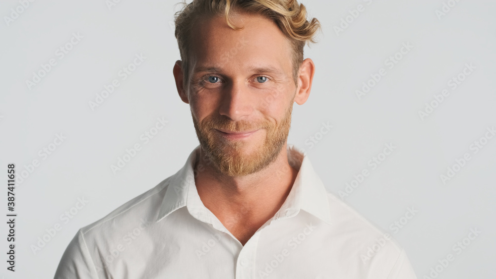 Attractive bearded man looking happy on camera over white background. Face expression Attractive bearded man looking happy on camera over white background. Face expression