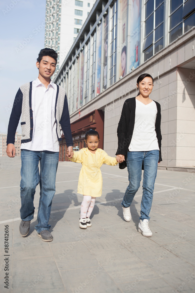 A happy family of three to go shopping A happy family of three to go shopping