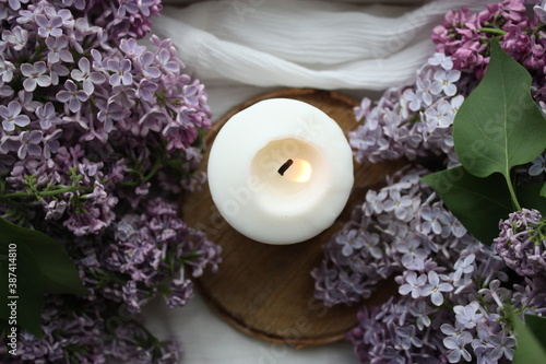 Lilacs and a candle in a home interior