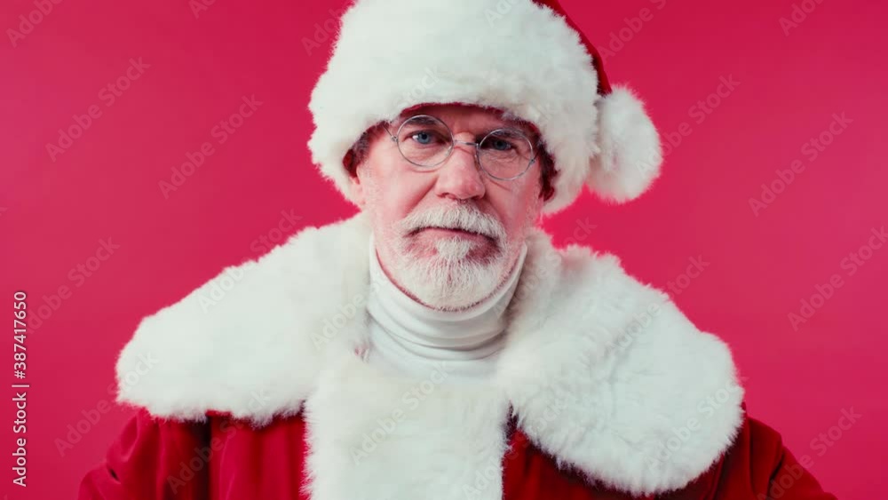 serious santa claus wagging finger at camera isolated on red serious santa claus wagging finger at camera isolated on red