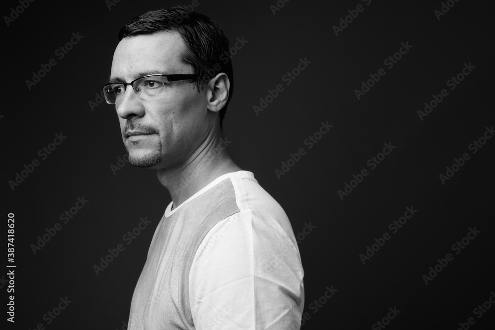 Obraz premium Portrait of handsome man with beard stubble against gray background