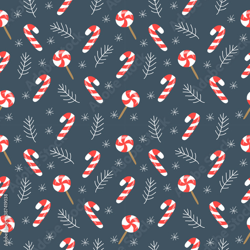 vector seamless pattern on christmas theme with caramel cane, fir branches and snowflakes on dark blue background