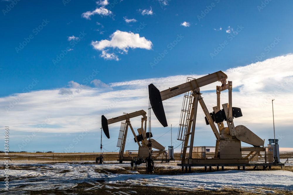 Oil derrick pumps on the prairies, Rockyview Country, Alberta, Canada Oil derrick pumps on the prairies, Rockyview Country, Alberta, Canada