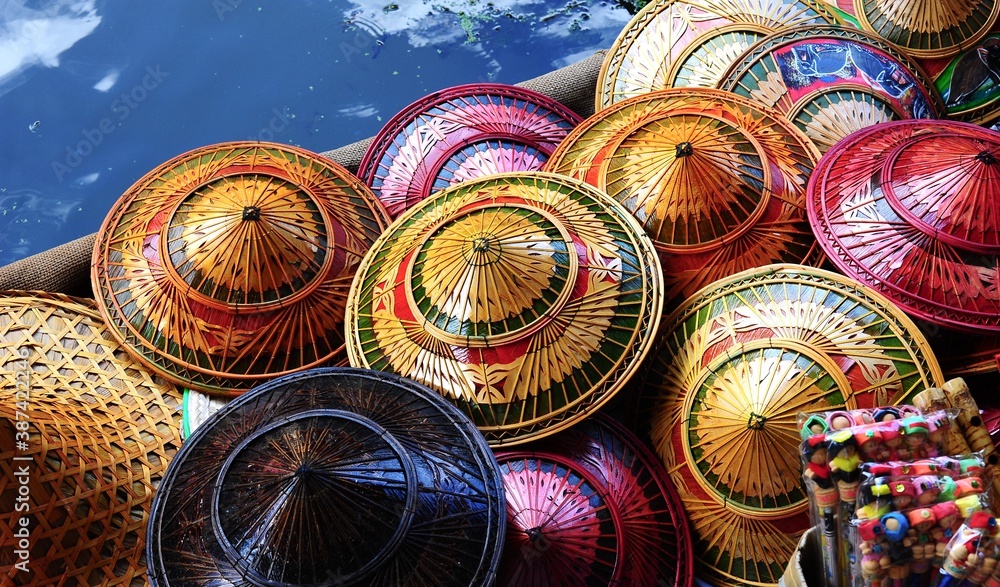 Colorful Thai hats sold for tourists- Floating Market, Thailand.