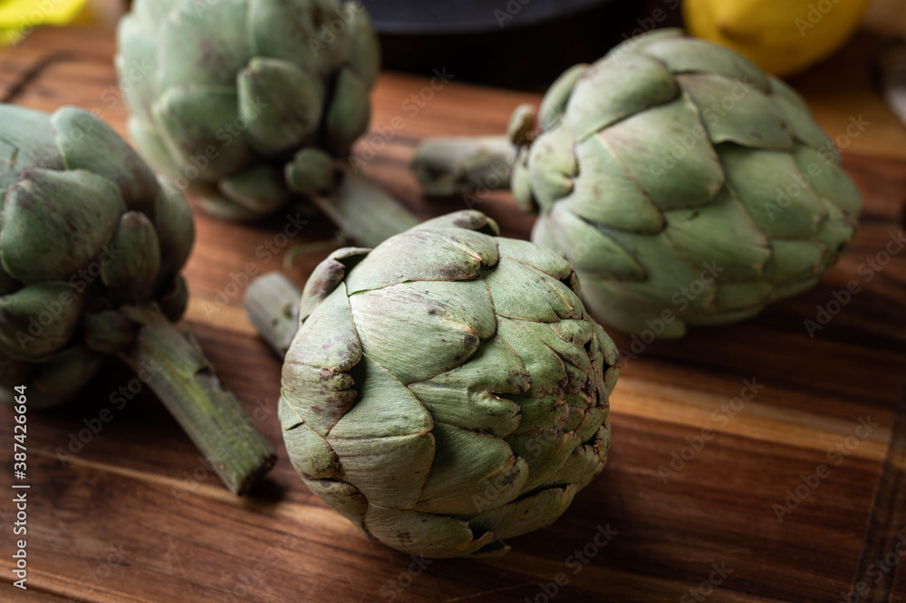 Fototapeta premium artichoke on wooden board at kitchen
