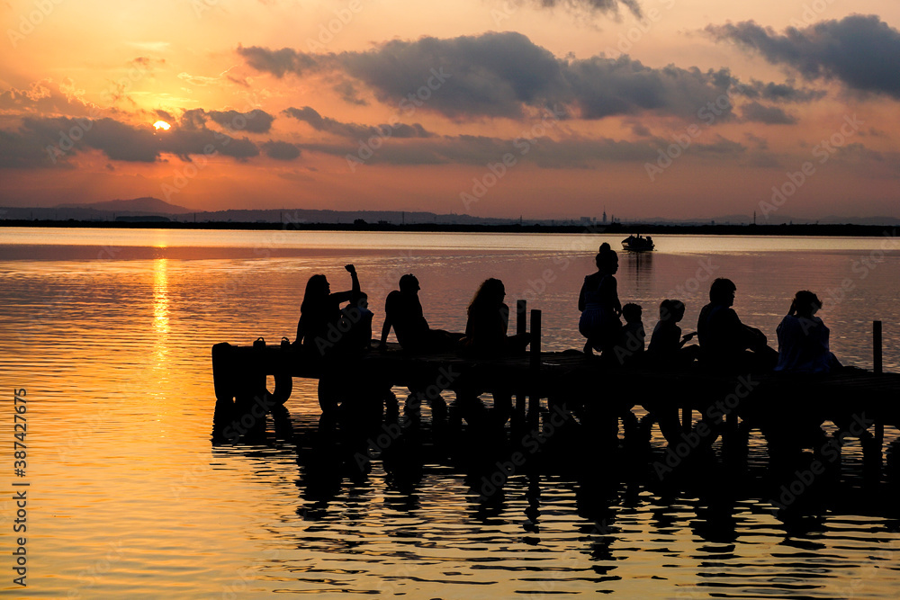 Fototapeta premium people watching the sunset in the Albufera of Valencia