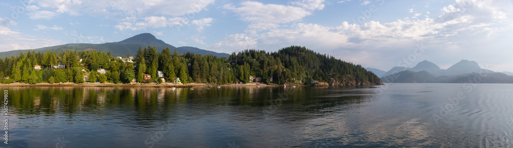 Panoramic View of Residential Homes on the Ocean Coast during a sunny summer morning. Taken in Gibsons, Sunshine Coast, British Columbia, Canada.
