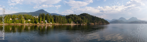 Panoramic View of Residential Homes on the Ocean Coast during a sunny summer morning. Taken in Gibsons  Sunshine Coast  British Columbia  Canada.