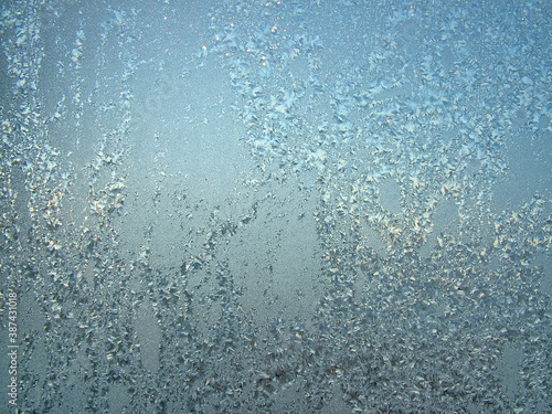 Snow patterns on window glass in contra sunlight