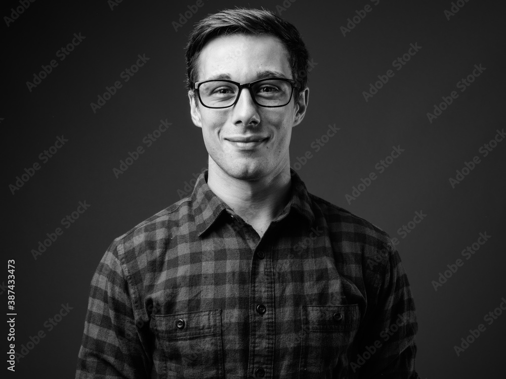 Young handsome hipster man in black and white - obrazy, fototapety, plakaty 