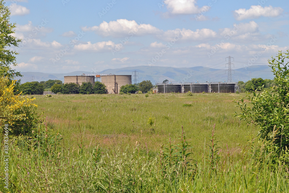 Country Landscape with Hills Blue Sky & Industrial Storage Tanks
