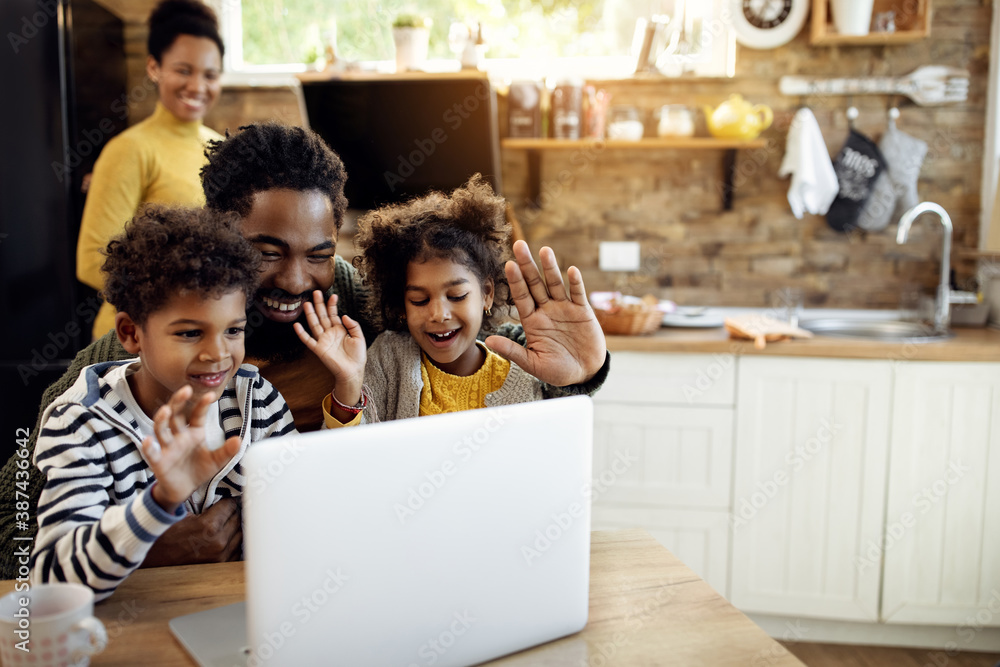 Happy black family making video call over laptop and waving to someone ...