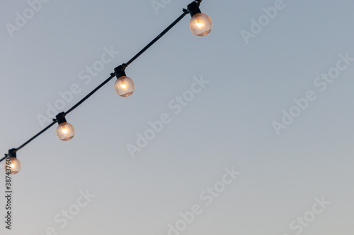 light bulbs garlands on a background of blue sky.