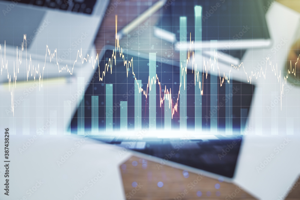 Multi exposure of abstract financial graph and modern digital tablet on desktop on background, top view, financial and trading concept Multi exposure of abstract financial graph and modern digital tablet on desktop on background, top view, financial and trading concept