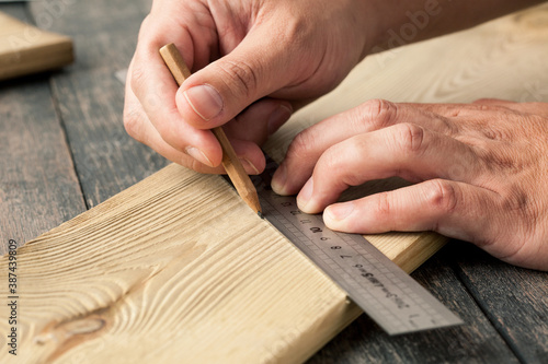 Man measuring a piece of wood