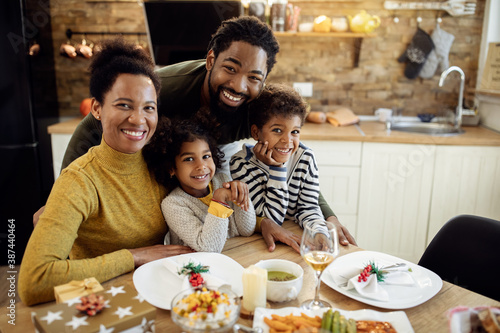 Happy African American family at dining table on Christmas day.