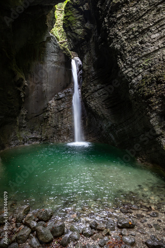 Slap Kozjak waterfall emerging into cave pool near Kobarid, Slovenia