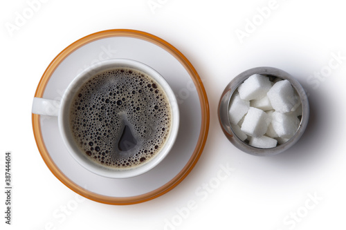 top view of white sugar cube and cup of black coffee