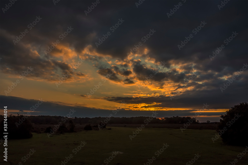 Sunset over the heathland in the New Forest near Fordingbridge, UK in Autumn Sunset over the heathland in the New Forest near Fordingbridge, UK in Autumn