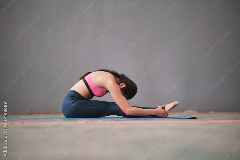 Portrait of gorgeous young women practicing yoga indoor. Calmness and relax, female happiness.