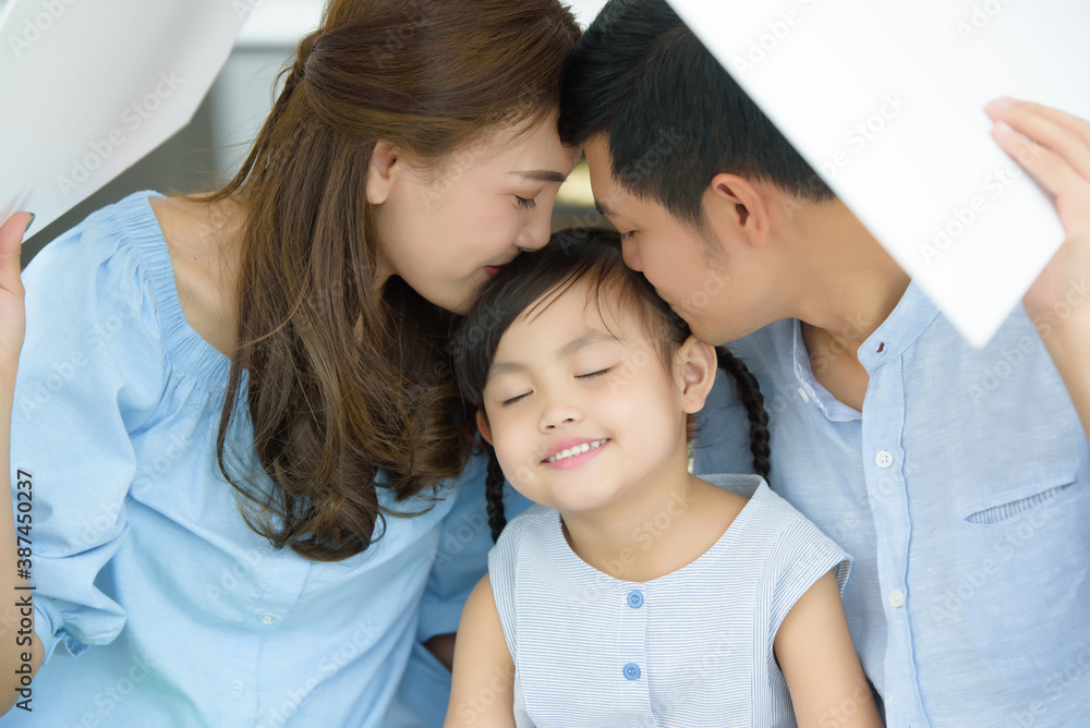 Asian young family happy to playing housing, Mother with Father and Children at living room in new home. New life family, Stable housing concept. Soft focus on Children center. Asian young family happy to playing housing, Mother with Father and Children at living room in new home. New life family, Stable housing concept. Soft focus on Children center.