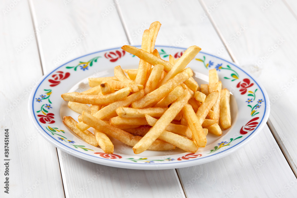 golden french fries on the wooden background golden french fries on the wooden background