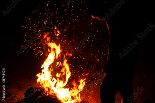 Boy in front of the fire of a bonfire