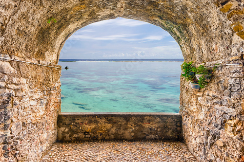 Rock balcony overlooking a tropical beach, French Polynesia