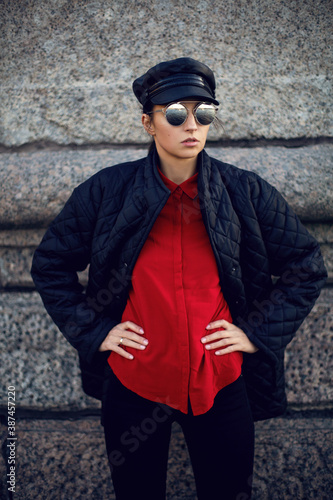 woman in black clothes jacket pants cap and red shirt