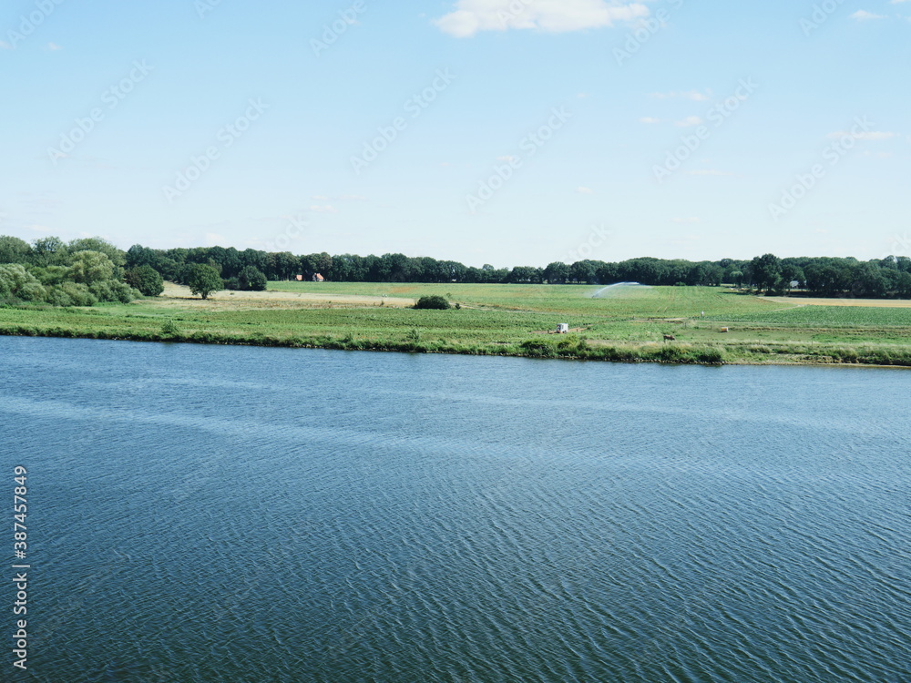 View to the landscape near Kessel, Netherlands, of the Maas river, the course of the river bed and the agricultural areas on the banks