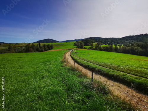 A dirt road leading through meadows. Gorce Mountains Poland