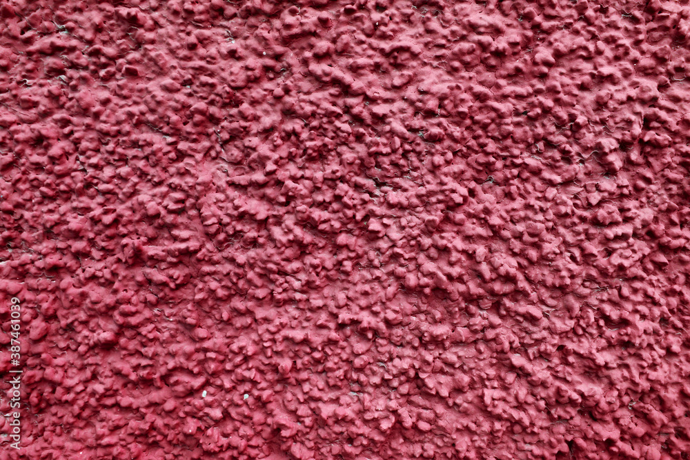 Fototapeta premium Popcorn ceiling texture of a red wall with color - rough surface background 