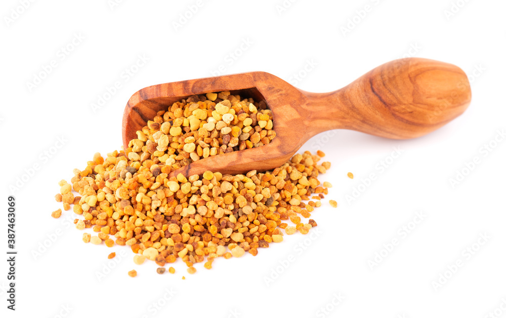 Flower pollen grains in wooden scoop, isolated on white background. Pile of bee pollen or perga. Flower pollen grains in wooden scoop, isolated on white background. Pile of bee pollen or perga.